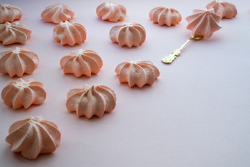 Diagonal row of sweet fresh dessert on a uniform background with a vintage fork