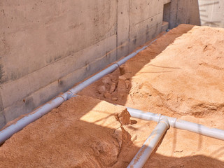 Junction of plastic sewer pipes. Sewage pipeline system of residential building under construction