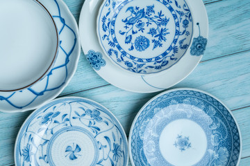 a ceramic dish with blue patterns on a rustic blue wood background