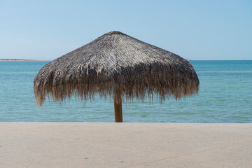 Palapa in a sunny day in the malecon of La Paz, with the sea of cortes on the background, in the state of Baja California Sur. Mexico