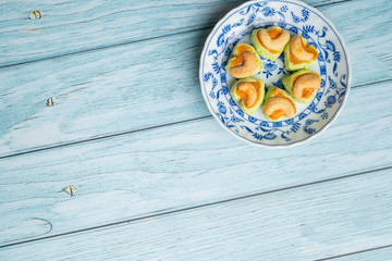 Thai Traditional Cookie on Blue Dish and Wooden Round Board with Blue Rustic Old Wooden Table
