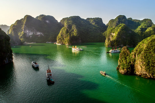 Aerial view floating fishing village and rock island, Halong Bay, Vietnam, Southeast Asia. UNESCO World Heritage Site. Junk boat cruise to Ha Long Bay. Popular landmark, famous destination of Vietnam