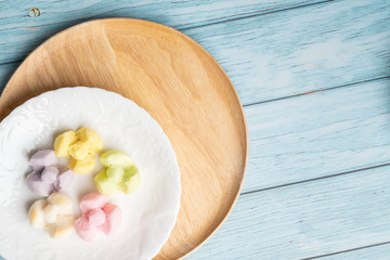 Thai Traditional Cookie on Blue Dish and Wooden Round Board with Blue Rustic Old Wooden Table