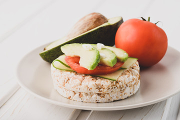 Vegan breakfast rice cake with avocado and tomato