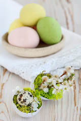 Simple Easter decoration with egg shell, cherry blossom twigs, catkins and moss. Final result