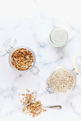 Jars of homemade granola and oatmeal with yogurt.