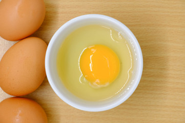 Close-up view of raw chicken eggs on background