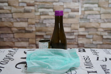 Corona Passover. Dust mask, bottle of wine and matzah - a traditional Jewish food for Passover