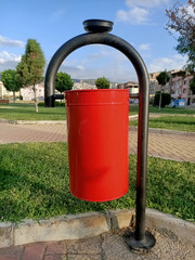 red trash can in  park