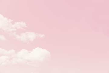Beautiful white soft fluffy clouds on a pale pink sky background