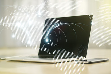 Double exposure of abstract digital world map with connections on laptop background, research and strategy concept