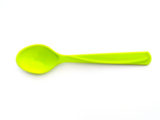 Green plastic spoon isolated on white background