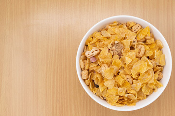 cereal in a white bowl on wooden background. Healthy breakfast concept.