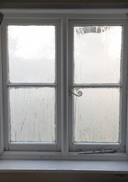 Condensation on old window in winter in England, UK