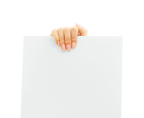 Blank white poster in a female hand for copy-space.