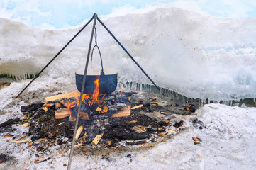 A fire pot using for cooking fish soup during camping on lake Baikal, Russia. Local fisherman...