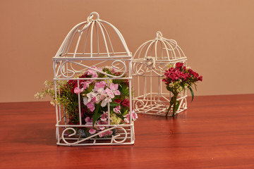 Bouquet of flowers, bird cage flower arrangement and vintage wedding decorations with burning candle