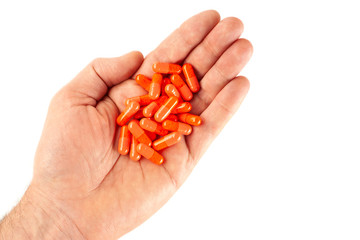 Man's hand isolated on white background with vitamin pills
