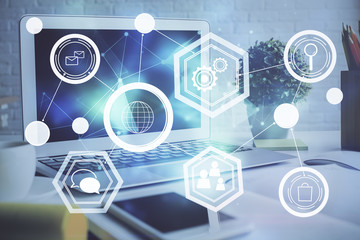 Computer on desktop with social network hologram. Multi exposure. Concept of international people connections.