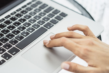 Woman working with laptop, business and technology concept. Close up