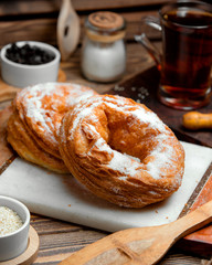 a roll of puff pastry sprinkled with powdered sugar