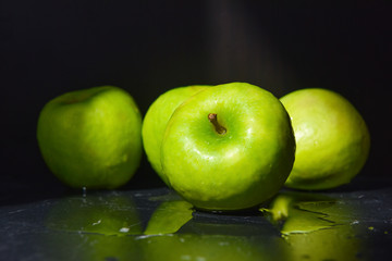 ripe green apples are covered with water drops