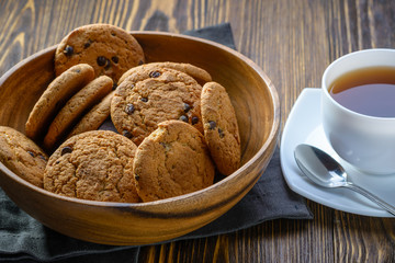 oatmeal cookies in a wooden bowl on a wooden table