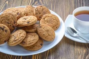 oatmeal cookies on a white dish on a wooden table