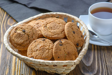 oatmeal cookies in a basket on a wooden table