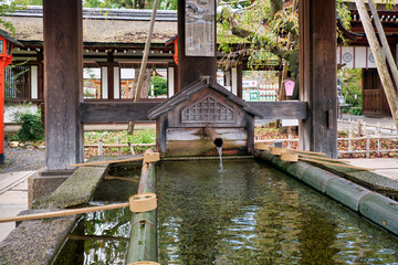 The water ablution pavilion (Chozuya or temizuya) at Hirano Shrine.  Kyoto. Japan