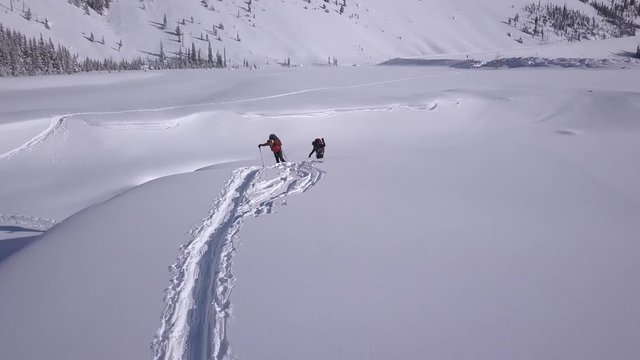 Aerial: Expedition skiers struggle to climb out of snowy riverbed