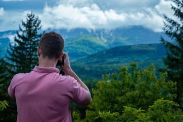 man looking at the mountains