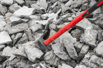iron hammer breaking stone into pieces. Large sledgehammer for construction