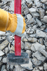 big sledgehammer in hand. iron hammer breaking stone into pieces	