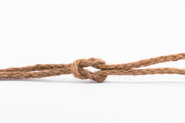 Old brown roped against a white background