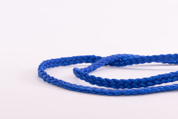 Blue string twisted and knotted against a white background
