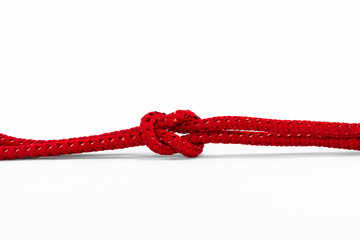knot on a red rope against a white background