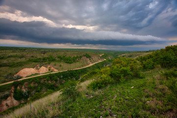 Naklejka premium river in green landscape and dramatic clouds with blue sky