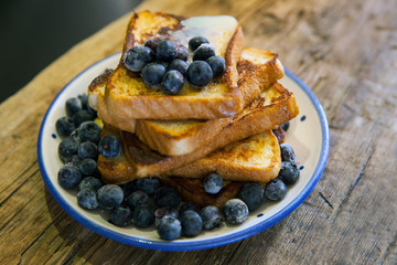 toasted bread with bluberries - French toast with berries blueberries, strawberries and sauce, traditional sweet dessert of bread with egg and milk. Morning baking food