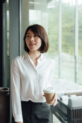 An Asian business woman with short hair is working