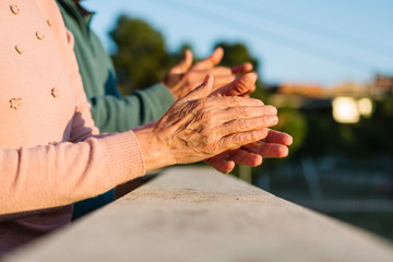 Senior man and woman applauding people who are fighting against coronavirus (covid19) from home