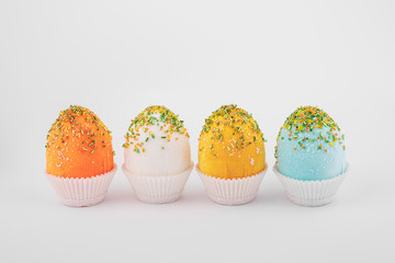 handmade decorative easter 
four eggs on a white background with textile and flower ornaments