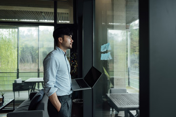 A young Asian business man is working