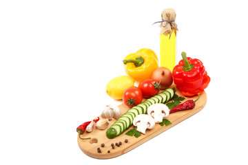 Slices of fresh vegetables on a cutting wooden board
