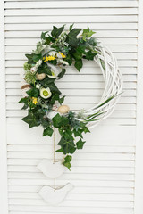 handmade Easter wreath made of duck eggs, greens and flowers, prepared for the Easter holiday, Easter composition