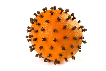 orange with cloves on a white background