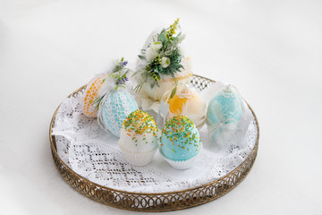 Easter composition of eggs in a basket, handmade, prepared for the holiday of Easter, on a white background