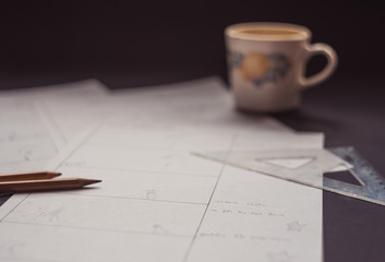 drawing a storyboard for the film indoors.