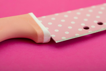pink knife on pink background