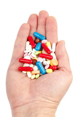 Pills, capsules in hand on white. Medicines and drugs.